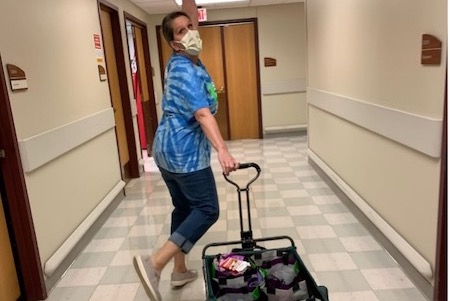 A person walking with a cart
