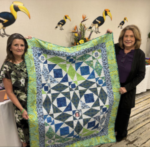 Linda Isaac with quilt made for her by a volunteer