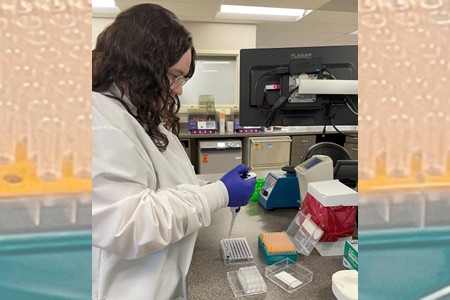 A woman in a lab coat testing samples.